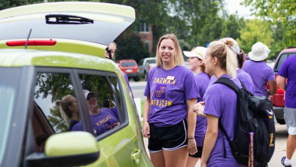 Students helping move people in